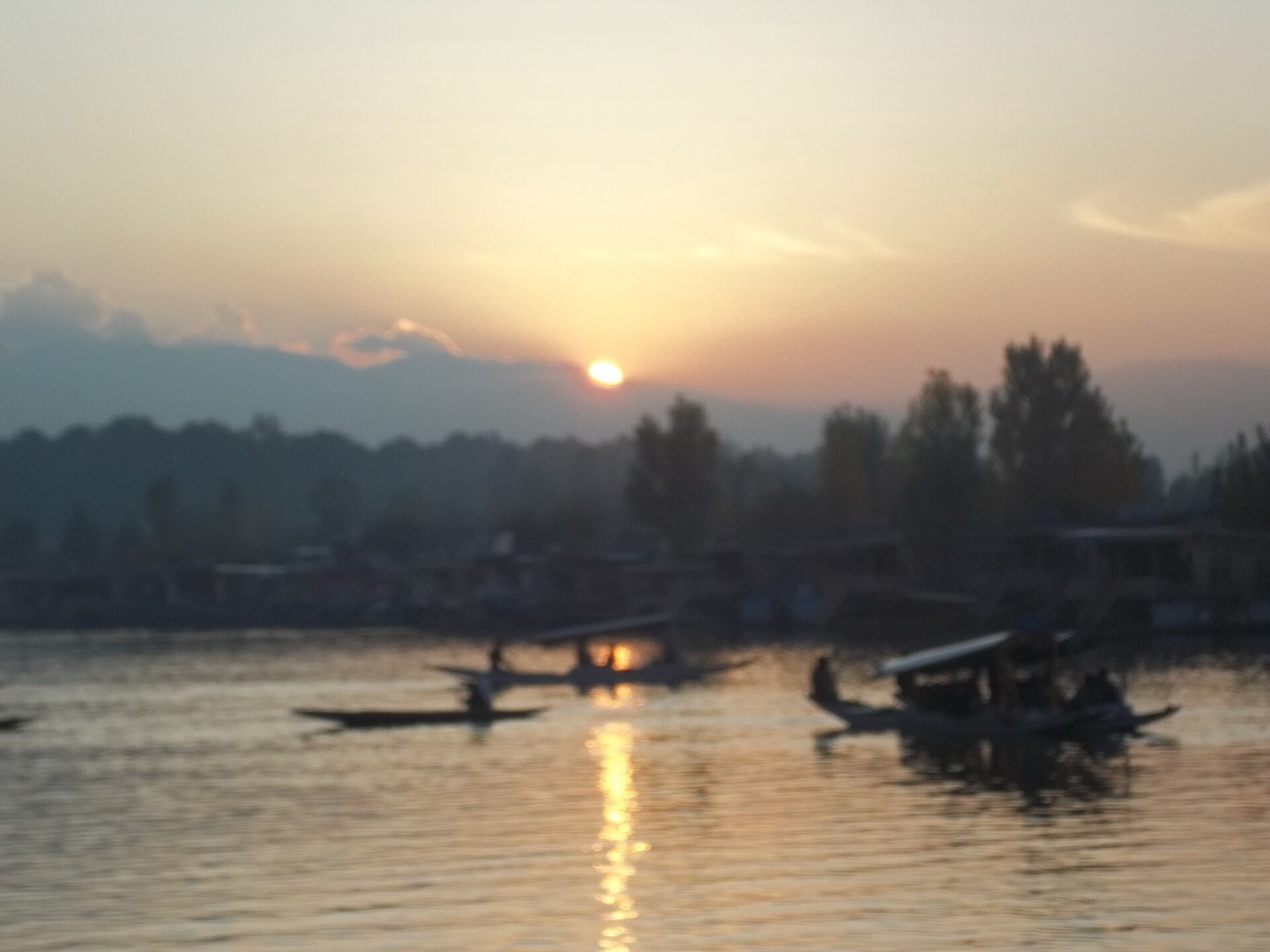 Shikaras crossing Dal Lake at sunset