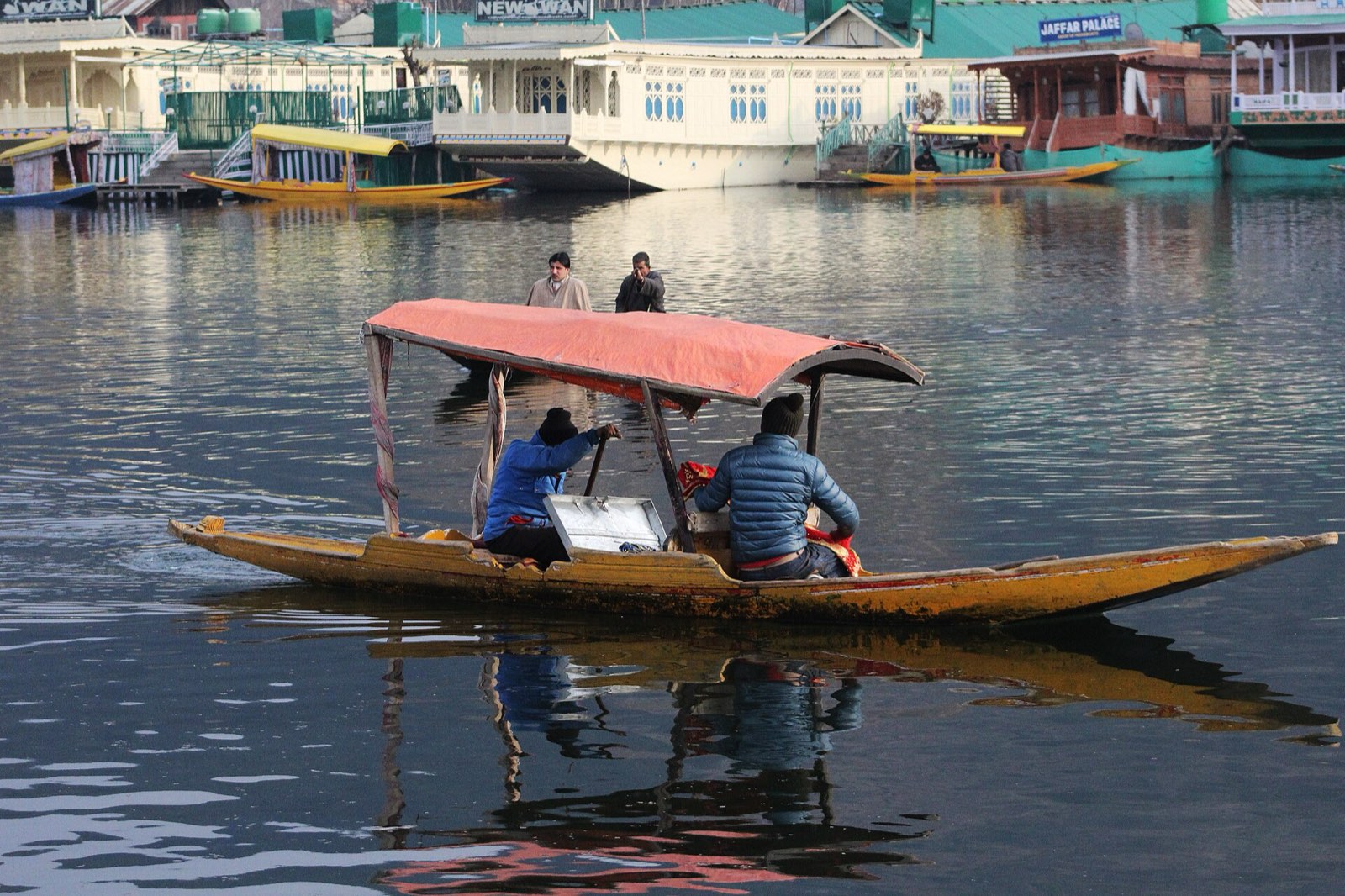 Two people in a shikara on Dal Lake